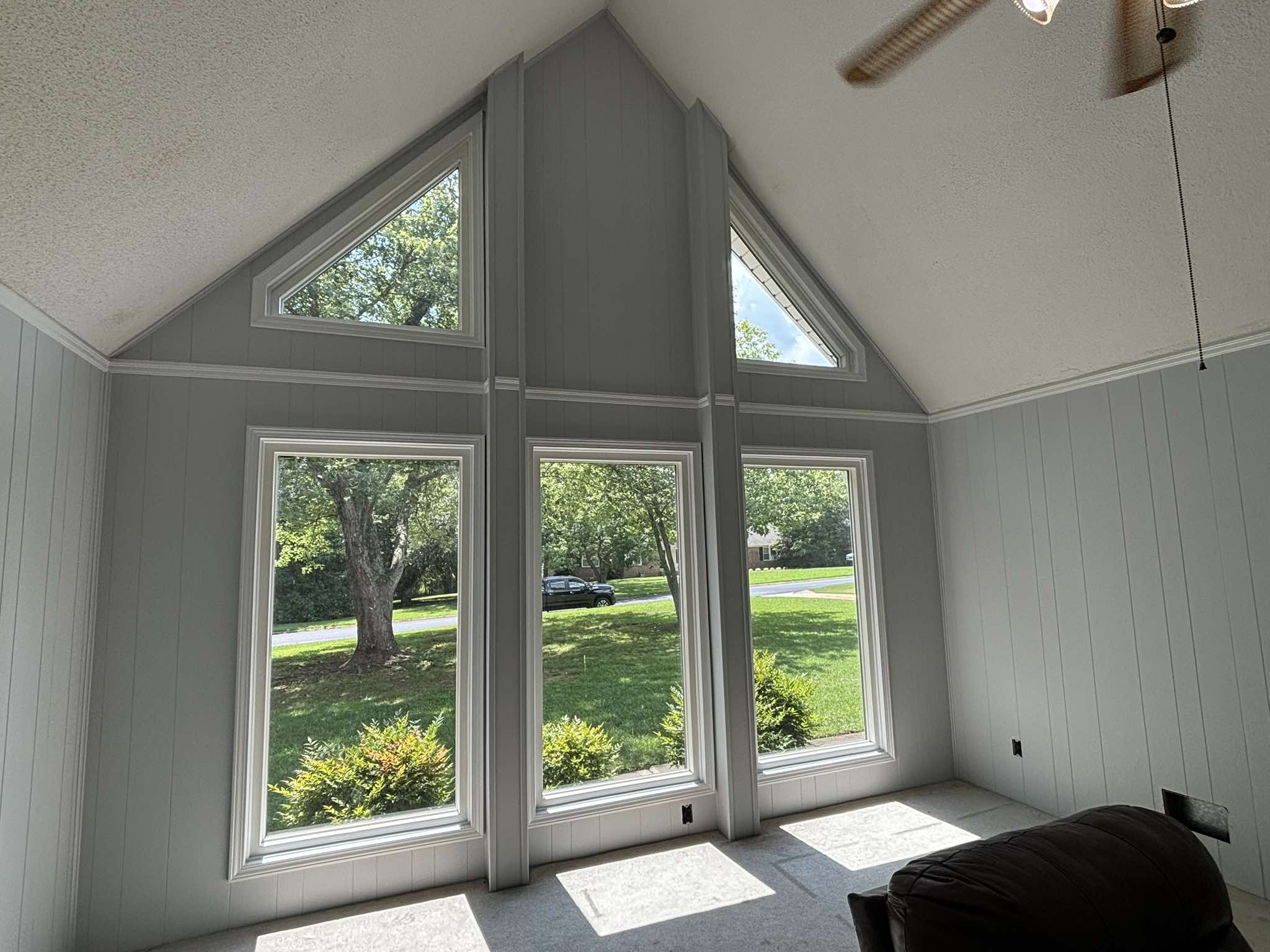 Finished vaulted interior with soft blue walls and bright white trim